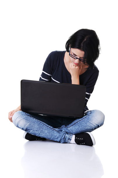 Sitting woman with a laptop - Фото, зображення
