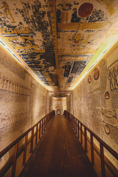 Luxor, Egypt - November 08, 2021: Majestic Interior View to the Corridor and Walls with hieroglyphics and other painting in the Pharaoh Tomb in the Valley of the Kings - Photo, Image