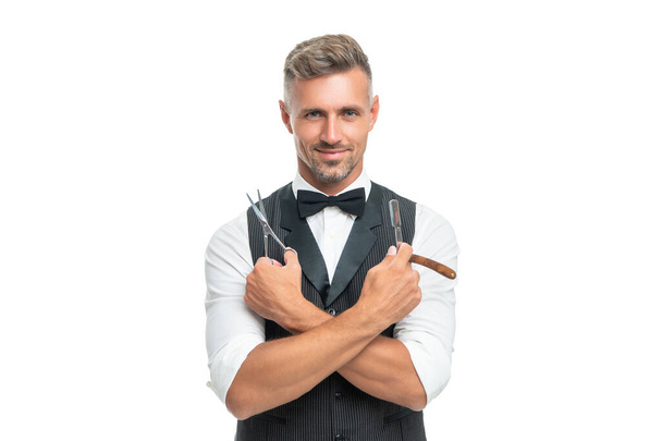 happy man barber with razor blade and scissors in bow tie isolated on white background - Foto, Imagem