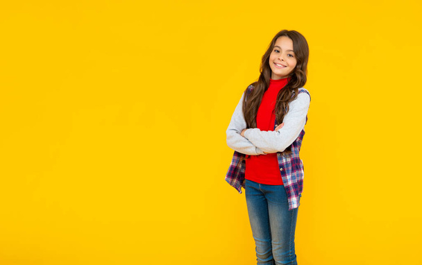 back to school. female fashion model. kid in casual clothes on yellow background. - 写真・画像
