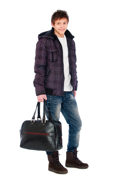 Young man in coat holding bag - Valokuva, kuva