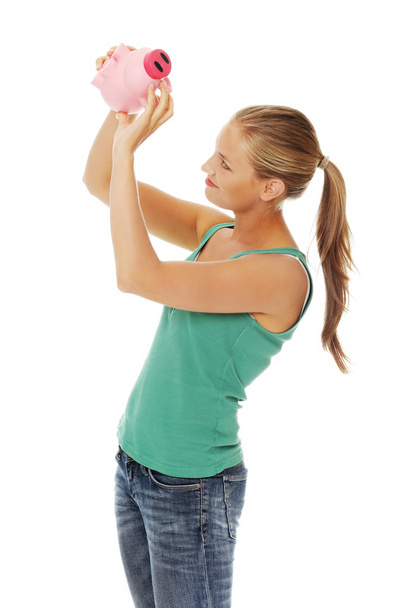 Woman holding piggybank - Фото, изображение