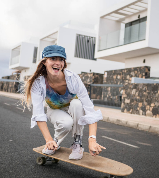 Real skater young woman skating, smiling, having fun - Photo, Image