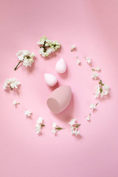 flat lay composition with cosmetic items and lilac flowers on a pink delicate background. Mothers day card, womens day - 写真・画像
