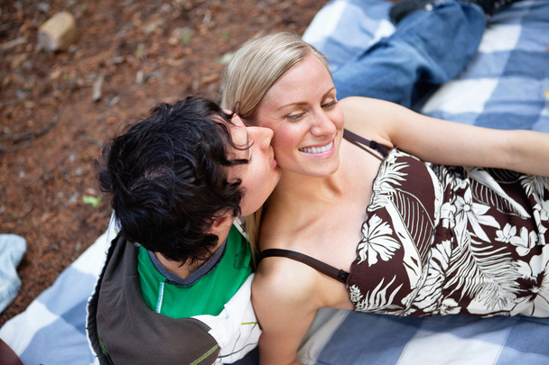 Romantic young guy kissing happy female - Фото, изображение