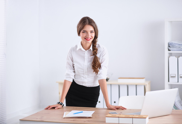 Attractive businesswoman with her arms crossed  standing in office - Фото, зображення