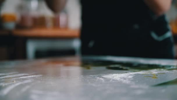 Female Hands are Kneading Yeast Dough, Tossing on a Table Sprinkled with Flour. Yellow, smooth dough for making bread, buns. Cooking sweet delicious pastries for the family at home. Slow-motion. - Footage, Video