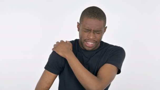 Hombre joven africano con dolor de hombro sobre fondo blanco  - Metraje, vídeo