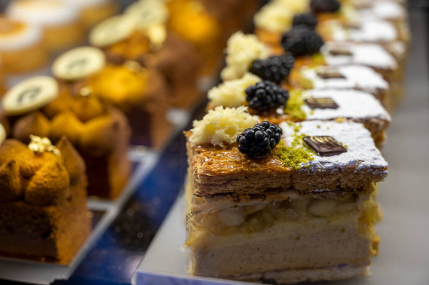 Austrian desserts, different types of chocolate and fruit cakes in traditional bakery cafe in Vienna, close up - Fotó, kép