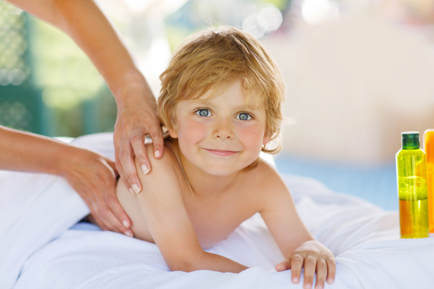 Adorable little blond kid relaxing in spa with having massage - Photo, Image
