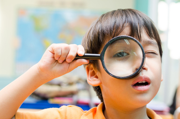 Little boy looking trough a binoculars map background - Foto, Imagen