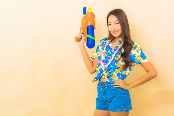 Portrait beautiful young asian woman wear colorful shirt for songkran festival on color background - Фото, изображение