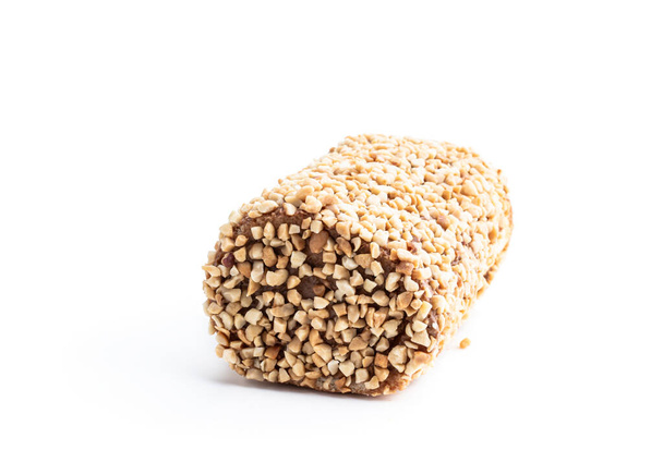 Sponge  cake roll covered with nuts isolated on white background  - Foto, Bild