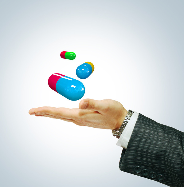 Pills on a businessman's hand - Fotó, kép