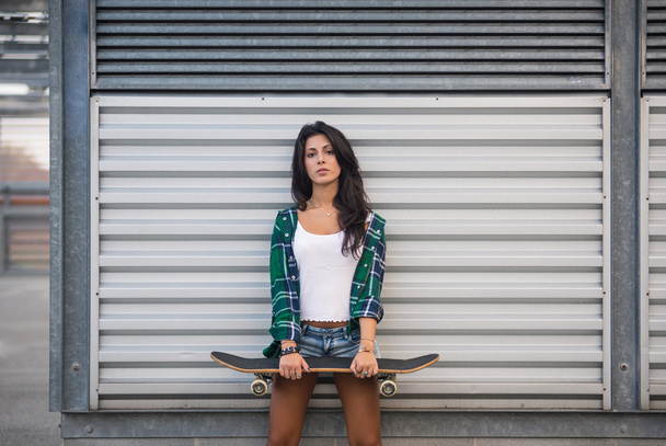 Teenager with skateboard portrait outdoors - Fotoğraf, Görsel