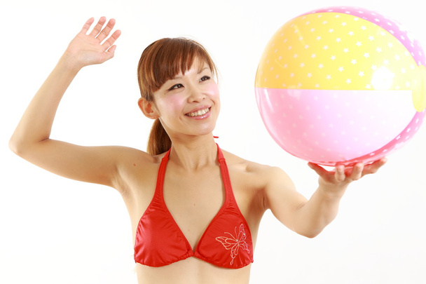 Young Japanese woman wearing bikini with beach ball - Valokuva, kuva
