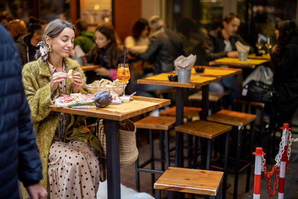 Woman with Italian snacks and drink at bar outdoors - Valokuva, kuva