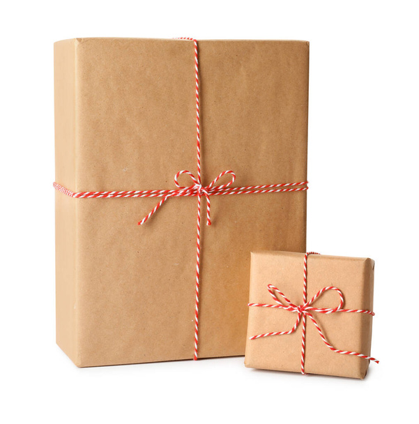 Gift boxes wrapped in kraft paper with bows on white background - Foto, Imagem