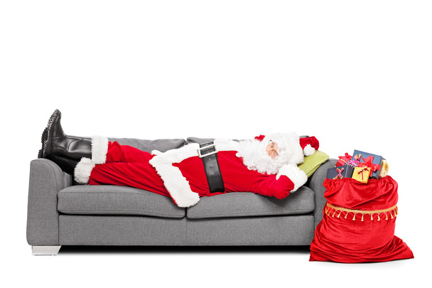 Santa sleeping on sofa - Фото, зображення