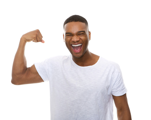 Happy african american man flexing arm muscle - Foto, immagini