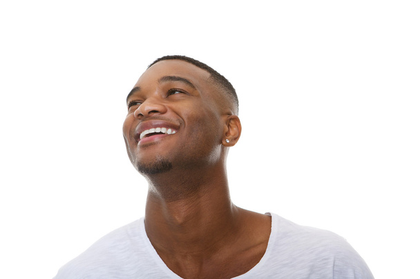 Close up portrait of a happy young african american man laughing - Photo, Image
