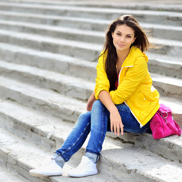 Young pretty stylish woman sitting on stairs  - Zdjęcie, obraz