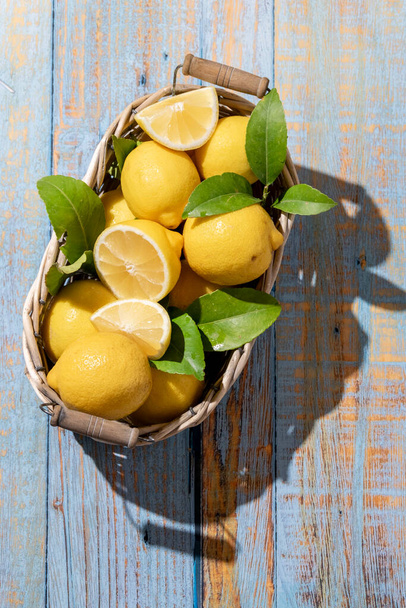 Raw fresh lemons on light wooden background. Harvest, agricultural concept, healthy organic ingredients - Foto, immagini