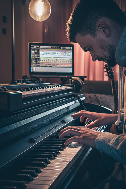 A man composer, producer, arranger, songwriter, musician hands arranging music. - Фото, изображение