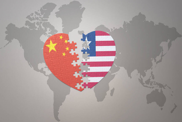 серце-головоломка з національним прапором Китаю та Ліберії на фоні карти світу. Поняття. 3D ілюстрація
 - Фото, зображення