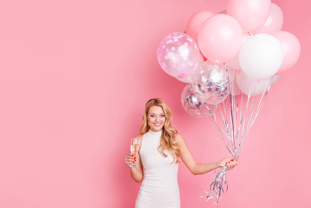 Portrait of cheerful adorable person hold champagne glass balloons isolated on pink color background - Photo, Image