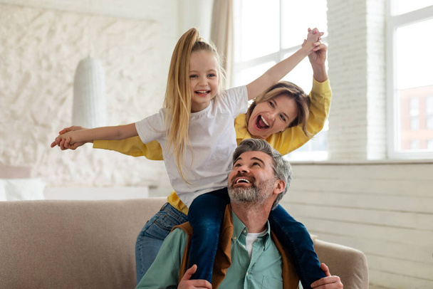 Cheerful Parents And Daughter Having Fun Bonding Playing At Home - Photo, Image