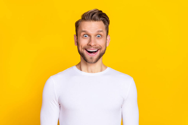 Portrait of impressed speechless man open mouth look camera isolated on yellow color background - Foto, Imagem