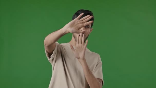 Emocional joven hindú hombre de negocios asustado freelancer tipo árabe cubrir la cara ondeando las palmas temerosos indio asustado estudiante masculino nervioso sensación de pánico evitar ver mal espiando a través de los dedos - Metraje, vídeo