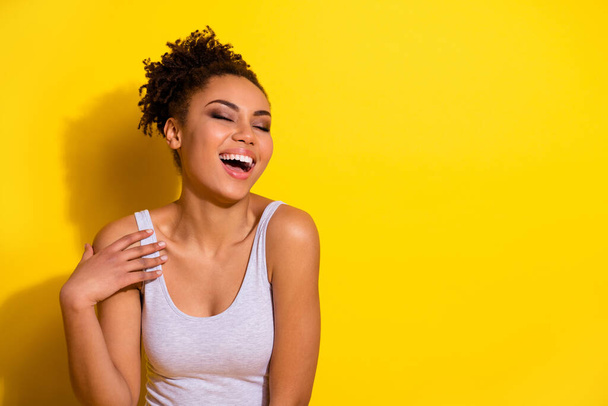 Photo of cheerful overjoyed girl closed eyes laughing have good mood isolated on yellow color background - Foto, Imagem