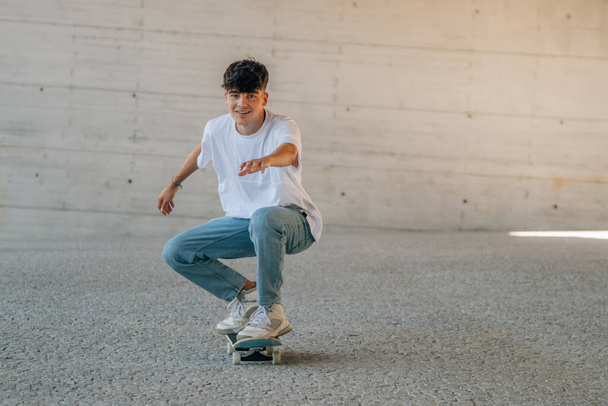 young man practicing with skateboard in the street - Photo, image