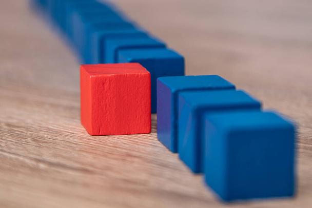 colored wooden blocks with one different highlighting - Foto, Bild
