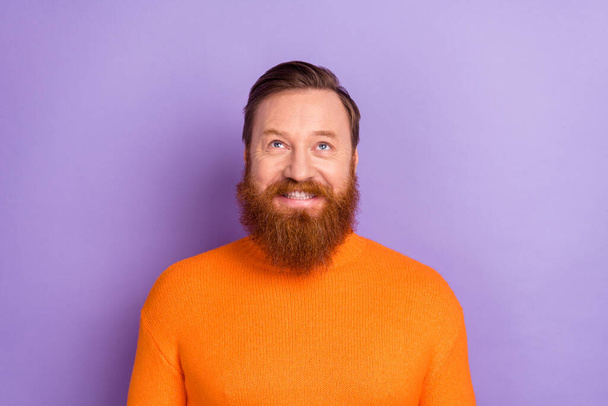 Photo of charming positive ginger man look up generate creative ideas isolated on violet color background - Fotó, kép