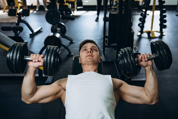 athlete in the gym jock workout training man boy exercise - Фото, изображение