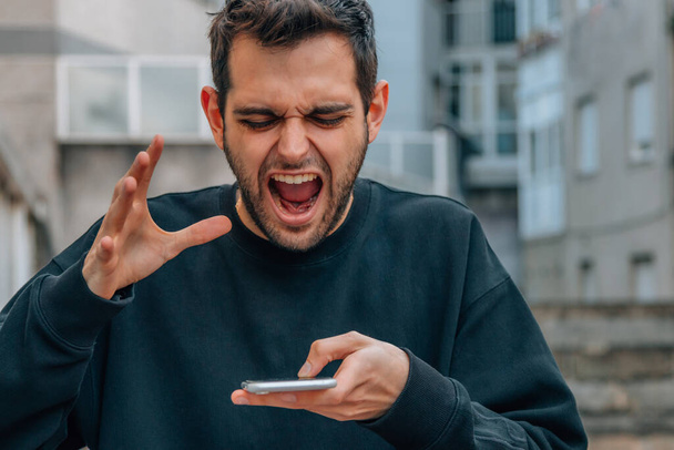 angry man yelling at mobile phone - Photo, Image