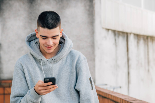 urban trendy millennial young man with mobile phone - Photo, Image