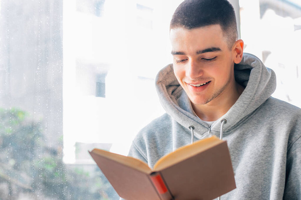 teenage boy reading a textbook - Photo, Image