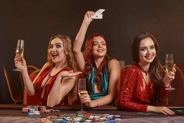 Три красиві молоді жінки грають в покер в казино
. - Фото, зображення