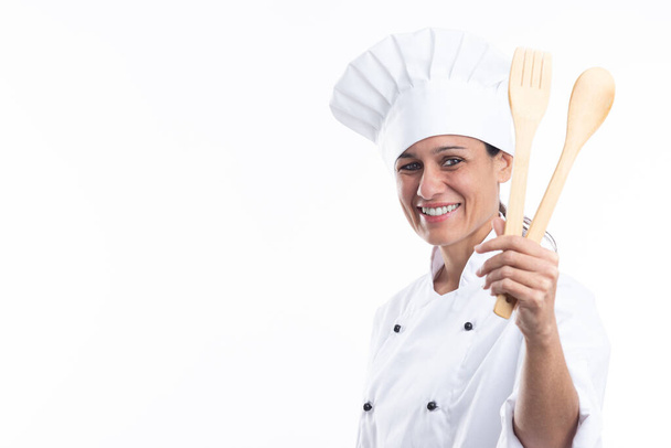 Portrait of happy caucasian woman looking at camera in chef outfit with kitchen tools in hands isolated on white background with copy space. - Photo, Image