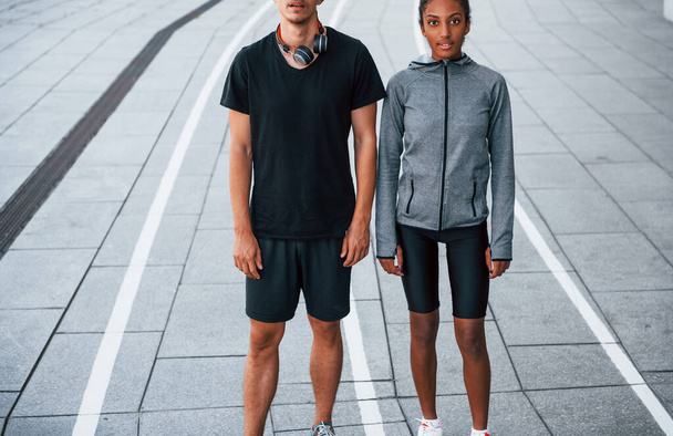 European man and african american woman in sportive clothes have workout together. - Fotoğraf, Görsel