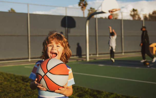 Basket ball excited child player laughing and having fun. Basketball kids school. - Φωτογραφία, εικόνα