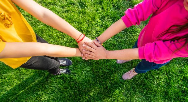 Children walk together holding hands. Selective focus. Kids. - Foto, afbeelding