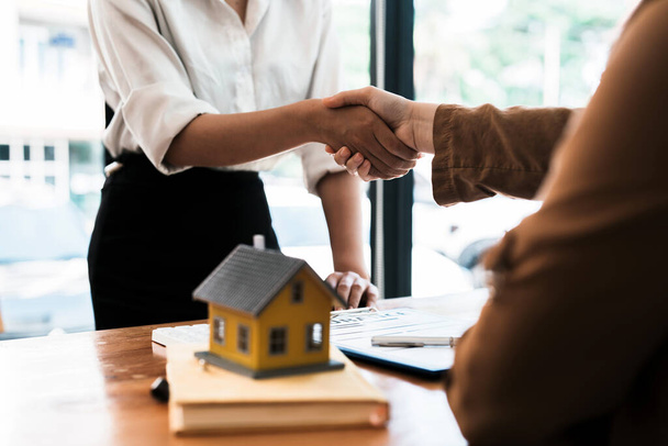 Successful agreement , estate,home buying contract concept, buyer shaking hand with bank empoyees after finishing signing contract in office - Photo, Image