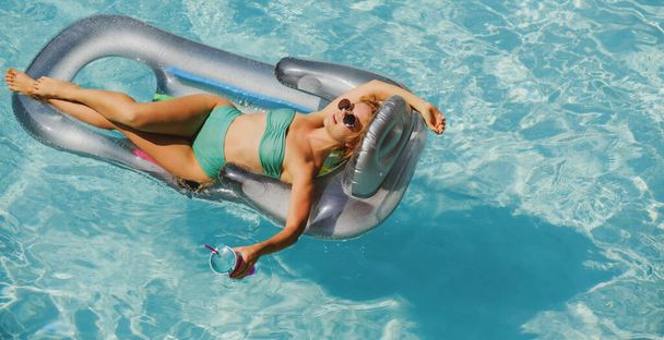 Summer vacation. Sexy woman in swimming pool. Summertime girl on inflatable mattress. - Photo, Image