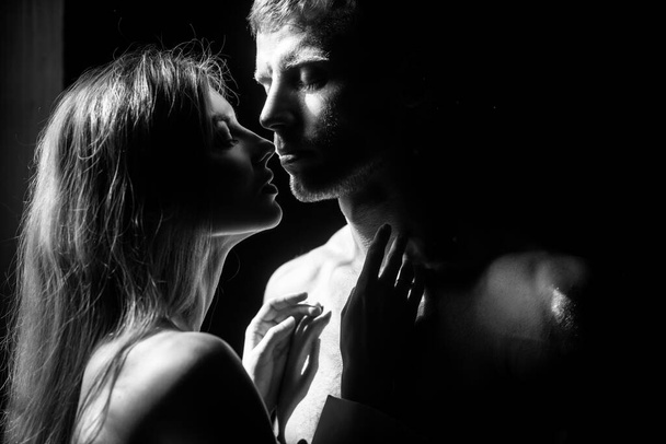 Beautiful passionate couple is having sex. Close up face of a beautiful young couple in love embracing, romance and and affection. - Fotó, kép