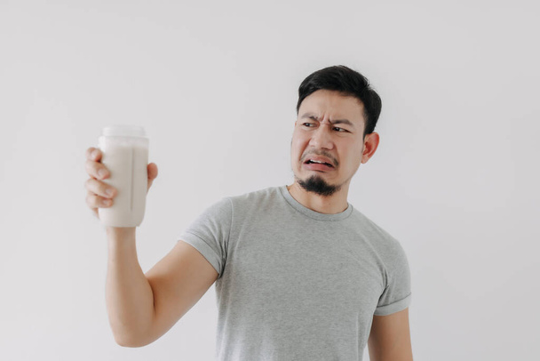 Man drink bad taste of protein chicken shake for health isolated on white. - Valokuva, kuva